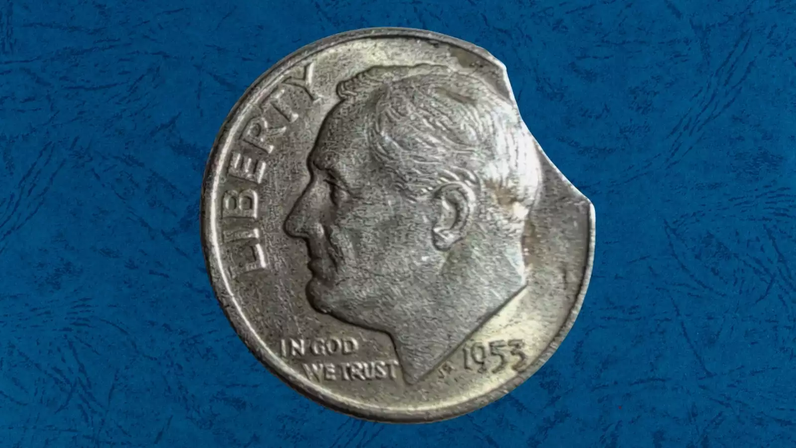 1953 Roosevelt dime clipped planchet error showing curved notch in rim and off-center strike error with design displaced from center